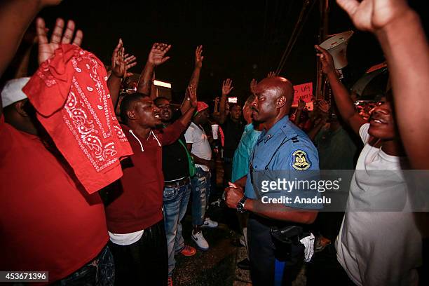 Capt. Ronald Johnson of the Missouri State Highway Patrol, listens to demonstrators protesting the shooting death of Michael Brown by a police...