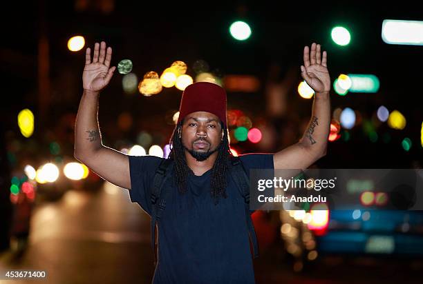 Demonstrator raises his hands to protest the shooting death of Michael Brown by a police officer, on West Florissant Avenue in Ferguson, Missouri, on...