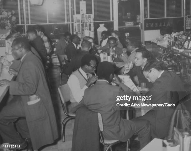 African American students from the Tuskegee Institute sit in a diner with white students from Stanford University in Alabama to protest segregation,...