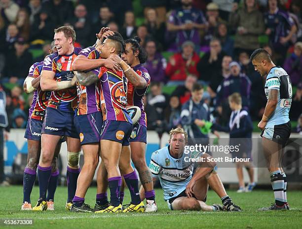 Jordan McLean of the Storm is congratulated by Tim Glasby and his teammates after scoring a try during the round 23 NRL match between the Melbourne...