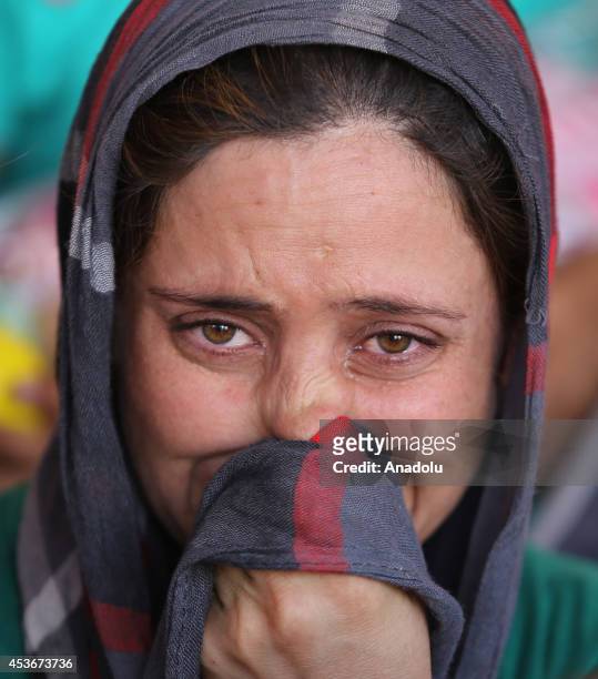 Yezidi woman Bese Hidir talks in tears after Iraqis escaping from attacks of army groups led by Islamic State , take shelter in Viransehir district...
