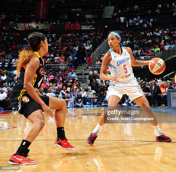 Jasmine Thomas of the Atlanta Dream handles the ball against Skylar Diggins of the Tulsa Shock on August 15, 2014 at Philips Arena in Atlanta,...