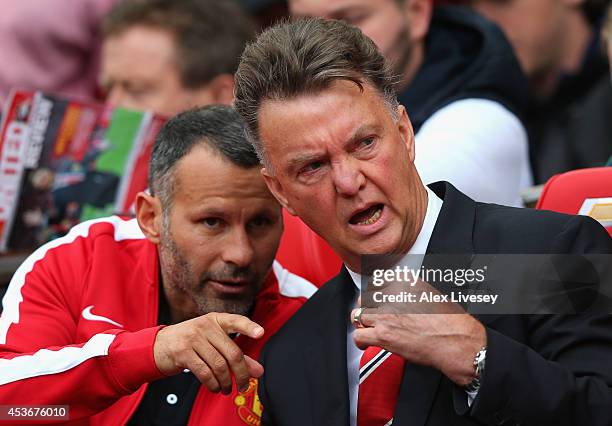 Manchester United Manager Louis van Gaal speaks with Assistant Ryan Giggs prior to the Barclays Premier League match between Manchester United and...