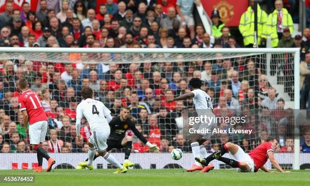 Ki Sung-Yeung of Swansea City scores the opening goal during the Barclays Premier League match between Manchester United and Swansea City at Old...