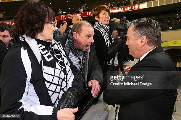 Magpies fan argues with President Eddie Mcguire after their defeat during the round 21 AFL match between the Collingwood Magpies and the Brisbane...