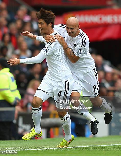 Ki Sung-Yeung of Swansea City celebrates scoring the opening goal with his team-mate Jonjo Shelvey during the Barclays Premier League match between...