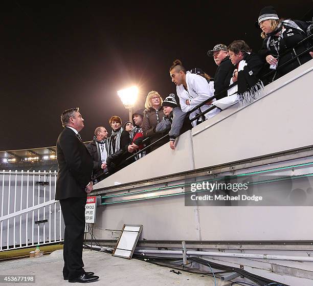 Disgruntled magpies fans talk with President Eddie Mcguire after their defeat during the round 21 AFL match between the Collingwood Magpies and the...