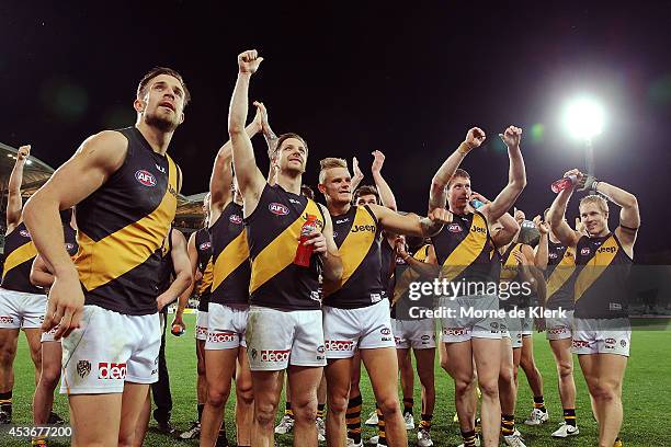 Tigers players celebrate after winning the round 21 AFL match between the Adelaide Crows and the Richmond Tigers at Adelaide Oval on August 16, 2014...