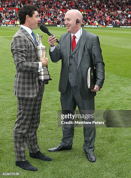 Golfer Rory McIlroy is interviewed by stadium announcer Alan Keegan during the Barclays Premier League match between Manchester United and Swansea...