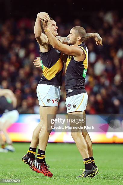 Dustin Martin and Shaun Grigg of the Tigers celebrate after the round 21 AFL match between the Adelaide Crows and the Richmond Tigers at Adelaide...