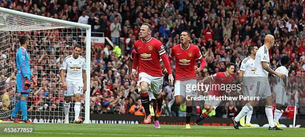 Wayne Rooney of Manchester United celebrates scoring their first goal during the Barclays Premier League match between Manchester United and Swansea...