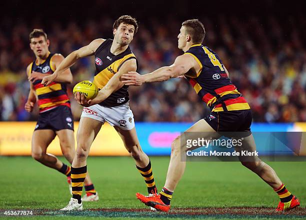 Ben Lennon of the Tigers passes the ball during the round 21 AFL match between the Adelaide Crows and the Richmond Tigers at Adelaide Oval on August...