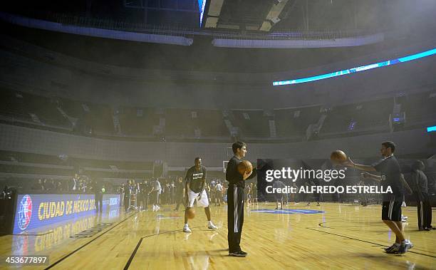 Players warm up at the smoke-filled Arena Ciudad de Mexico before the match between Minnesota Timberwolves and San Antonio Spurs in Mexico City on...