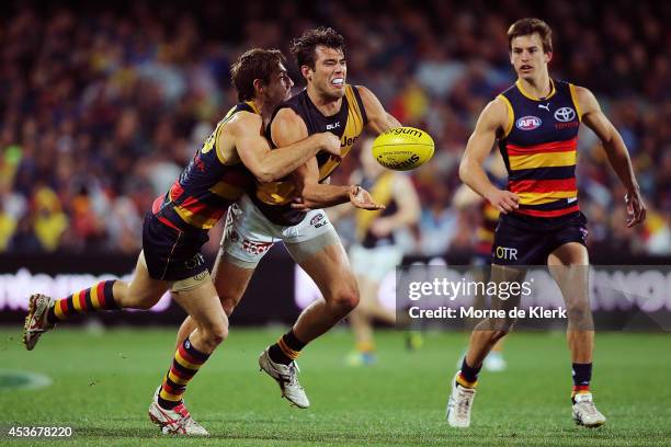 Richard Douglas of the Crows tackles Alex Rance of the Tigers during the round 21 AFL match between the Adelaide Crows and the Richmond Tigers at...