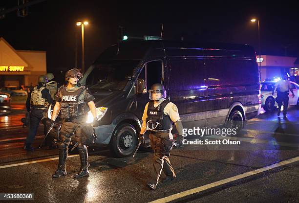 Police set up a perimeter to confront demonstrators during a protest over the shooting of Michael Brown on August 15, 2014 in Ferguson, Missouri....