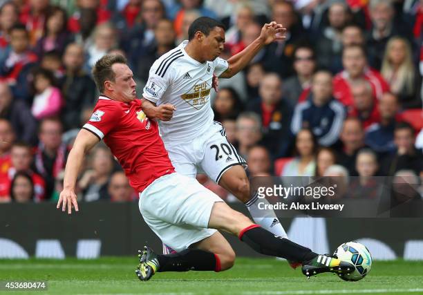 Phil Jones of Manchester United tackles Jefferson Montero of Swansea City during the Barclays Premier League match between Manchester United and...