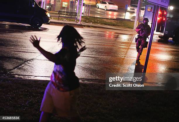 Police officer confronts a demonstrators during a protest over the shooting death of Michael Williams on August 15, 2014 in Ferguson, Missouri....