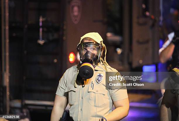 Police don riot gear to confront demonstrators during a protest over the shooting of Michael Brown on August 15, 2014 in Ferguson, Missouri. Police...