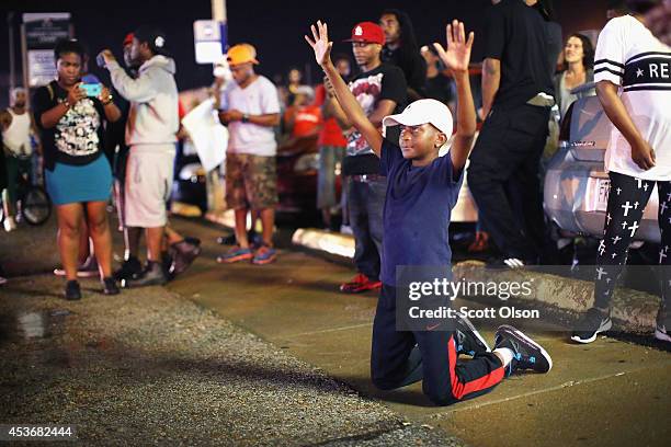 Demonstrators protesting the shooting death of Michael Williams confront police on August 15, 2014 in Ferguson, Missouri.Police shot pepper spray,...