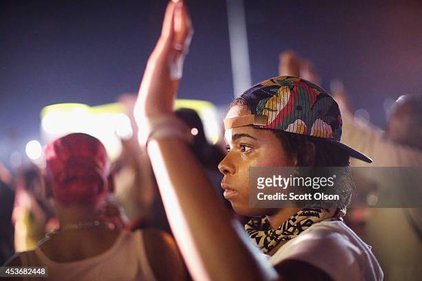 Demonstrators protesting the shooting death of Michael Williams confront police on August 15, 2014 in Ferguson, Missouri.Police shot pepper spray,...