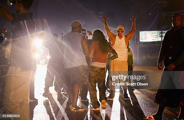 Demonstrators protesting the shooting death of Michael Williams confront police on August 15, 2014 in Ferguson, Missouri.Police shot pepper spray,...