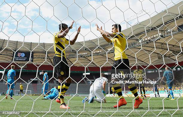 Henrikh Mkhitaryan of Dortmund celebrates with his team-mates after scoring his team's first goal during the DFB Cup first round match between...