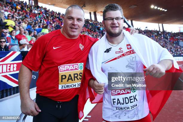 Krisztian Pars of Hungary celebrates as he wins gold alongside silver medalist Pawel Fajdek of Poland in the Men's Hammer final during day five of...