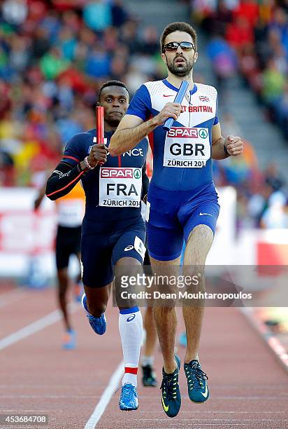 Martyn Rooney of Great Britain and Northern Ireland races to the line ahead of Thomas Jordier of France in the Men's 4x400 metres relay heats during...