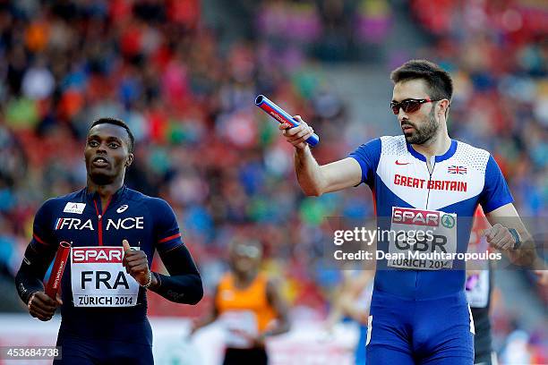 Martyn Rooney of Great Britain and Northern Ireland celebrates as Thomas Jordier of France looks on in the Men's 4x400 metres relay heats during day...