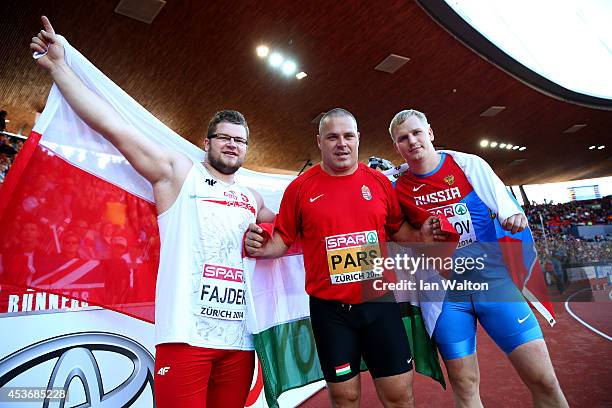 Silver medalist Pawel Fajdek of Poland, gold medalist Krisztian Pars of Hungary and bronze medalist Sergey Litvinov of Russia celebrate after the...