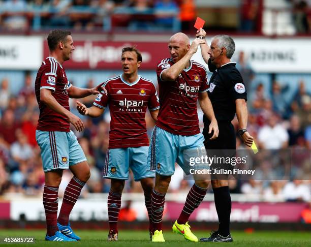 James Collins of West Ham reacts after receiving the red card for his second bookable offence during the Barclays Premier League match between West...