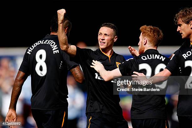 James Chester of Hull City celebrates scoring the opening goal against Queens Park Rangers with teammates l-r Tom Huddlestone, Stephen Quinn and...