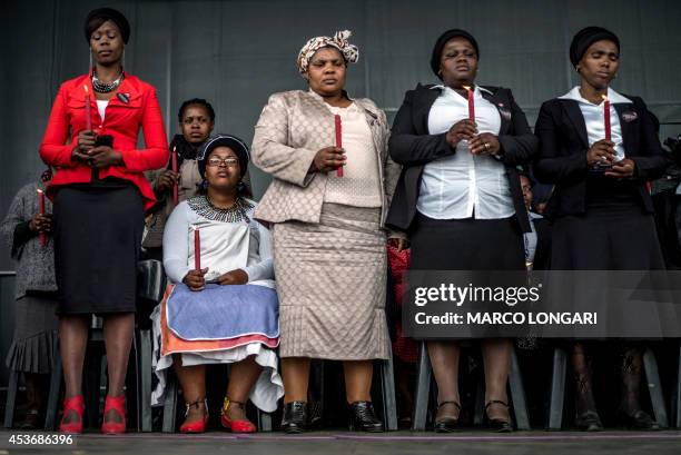 Widows and bereaved family members attend on August 16, 2014 in Marikana, a ceremony in tribute to miners who where gunned down by the South African...