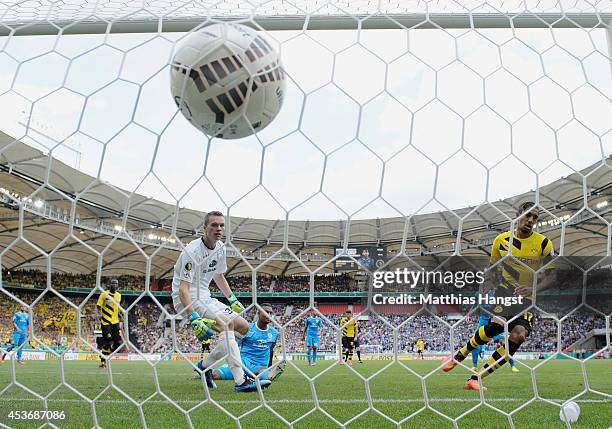 Pierre-Emerick Aubameyang of Dortmund scores his team's third goal past Royal Fennell of Stuttgarter Kickers and goalkeeper Mark-Patrick Redl of...