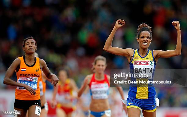 Meraf Bahta of Sweden celebrates as she crosses the finish next to Sifan Hassan of the Netherlands to win gold in the Women's 5000 metres final...