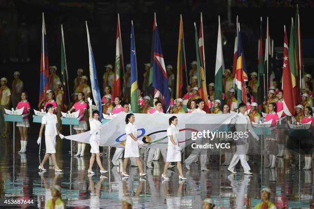 Eight athletes of China enter the stadium with the Olympic flag during the opening ceremony for the Nanjing 2014 Summer Youth Olympic Games at the...