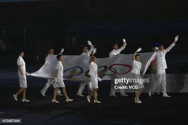 Eight athletes of China enter the stadium with the Olympic flag during the opening ceremony for the Nanjing 2014 Summer Youth Olympic Games at the...