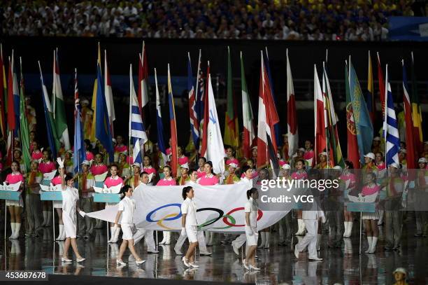 Eight athletes of China enter the stadium with the Olympic flag during the opening ceremony for the Nanjing 2014 Summer Youth Olympic Games at the...