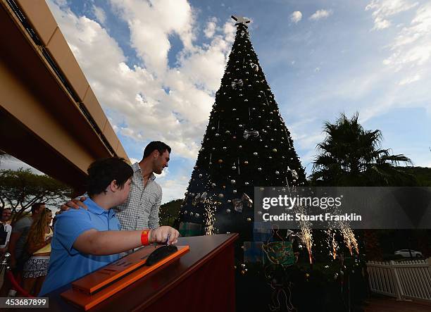 Martin Kaymer of Germany switches on the christmas lights on the tree prior to the start of the Nedban Golf Challenge at Gary Player CC on December...