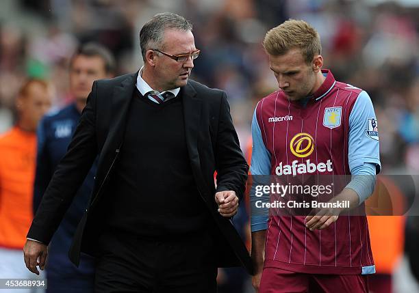 Aston Villa manager Paul Lambert speaks with Andreas Weimann as they leave the field at half-time during the Barclays Premier League match between...