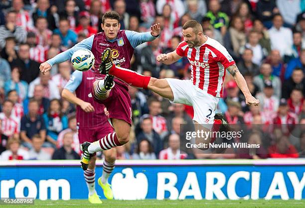 Ashley Westwood of Aston Villa is challenged by Phil Bardsley of Stoke City during the Barclays Premier League match between Stoke City and Aston...