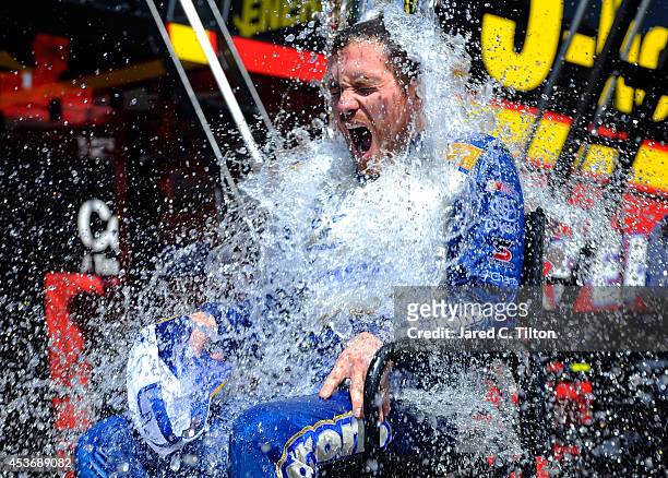 Brian Vickers, driver of the Aaron's Dream Machine Toyota, participates in the ALS Ice Bucket Challenge after practice for the NASCAR Sprint Cup...