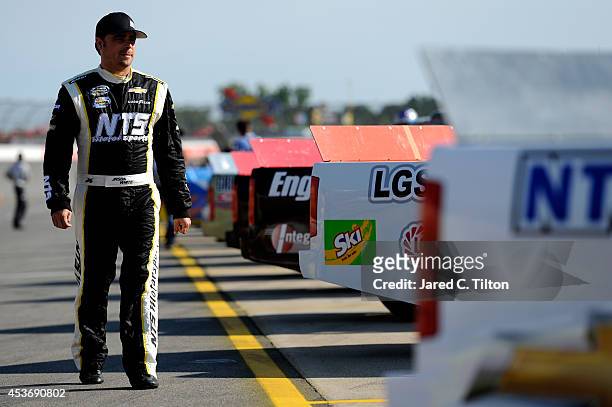 Jason White, driver of the Autism Speaks/NTS Motorsports Chevrolet, walks on the grid during qualifying for the NASCAR Camping World Truck Series...