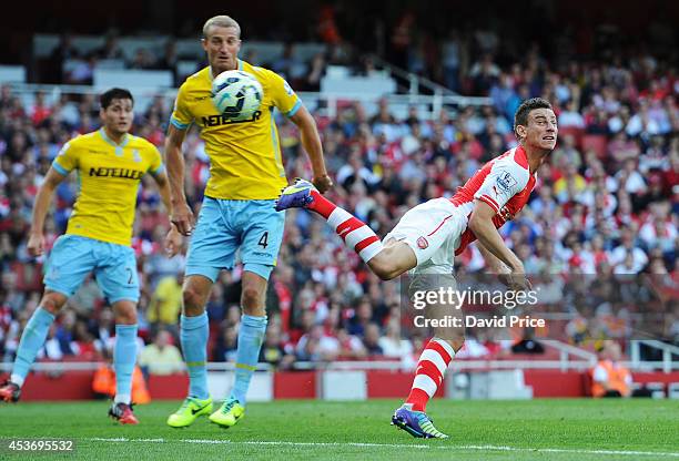 Laurent Koscielny scores a goal for Arsenal under pressure from Brede Hangeland during the Barclays Premier League match between Arsenal and Crystal...