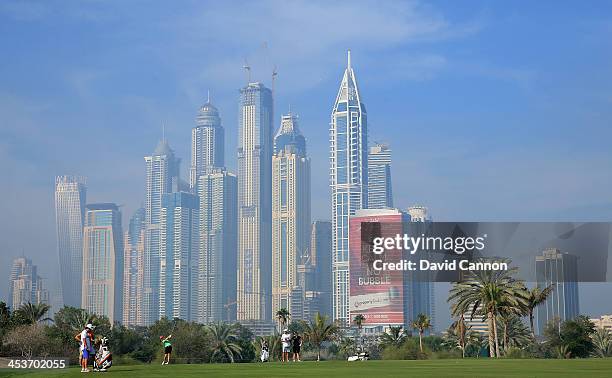 Charley Hull of England plays her second shot on the par 5, 13th hole during the second round of the 2013 Omega Dubai Ladies Masters on the Majilis...