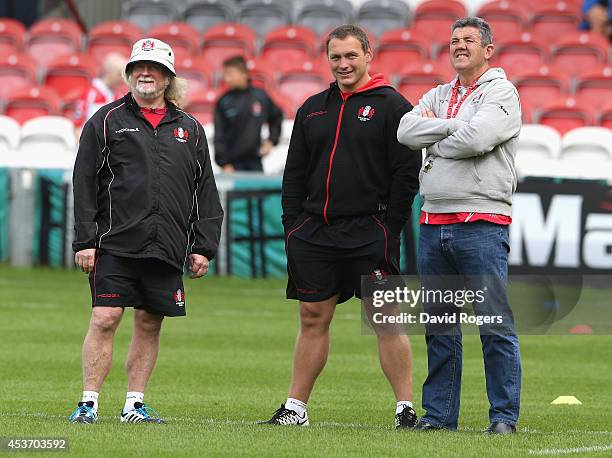 Laurie Fisher, the Gloucester head coach, looks on with scrum coach Trevor Woodman and defence coach John Muggleton during the pre season friendly...