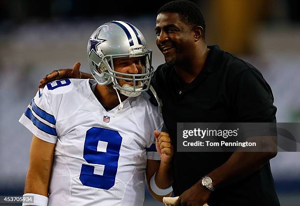 Tony Romo of the Dallas Cowboys and former Dallas Cowboy Greg Ellis share a laugh before the start of their game against the Baltimore Ravens at AT&T...