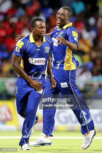 Kyle Mayers of Barbado Tridents celebrates with his teammate Raymon Riefer during the Limacol Caribbean Premier League 2014 final match between...