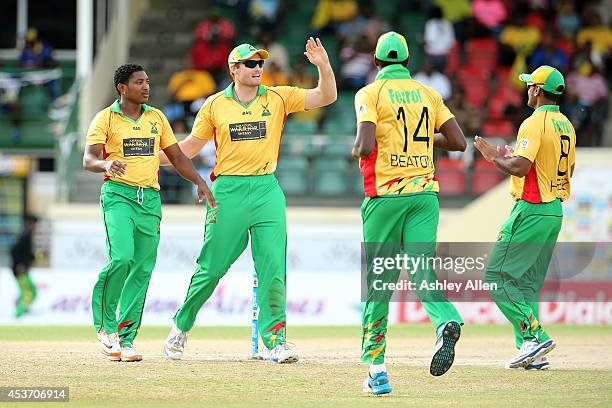 Players of Guyana Amazon Warriors celebrate a wicket during the Limacol Caribbean Premier League 2014 final match between Guyana Amazon Warriors and...