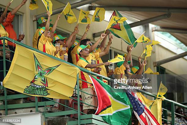 Guyana Amazon Warriors fans cheer for their team during the Limacol Caribbean Premier League 2014 final match between Guyana Amazon Warriors and...